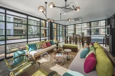 Spacious modern living room with vibrant decor and large windows in luxury apartment
