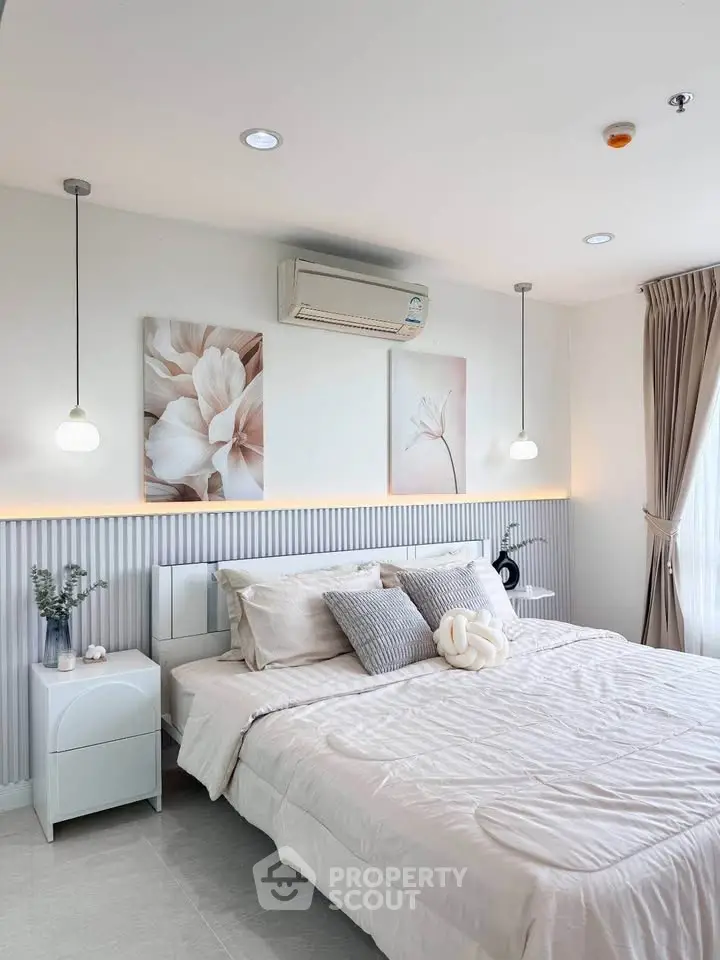 Elegant bedroom with modern decor, featuring a cozy bed, stylish lighting, and serene artwork, perfect for relaxation.
