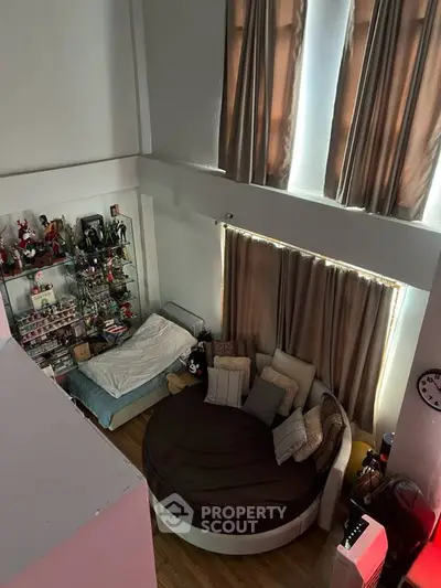 Spacious loft bedroom with high ceilings and cozy round bed