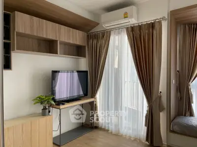 Modern living room with TV, air conditioning, and elegant curtains