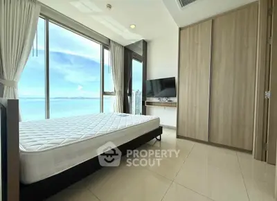 Spacious bedroom with stunning ocean view and modern furnishings