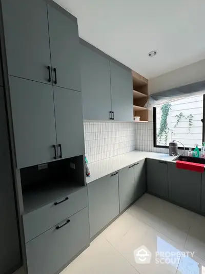 Modern kitchen with sleek cabinetry and natural light