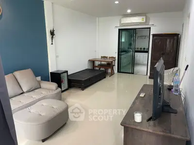 Spacious living room with modern furniture and air conditioning in a stylish apartment.
