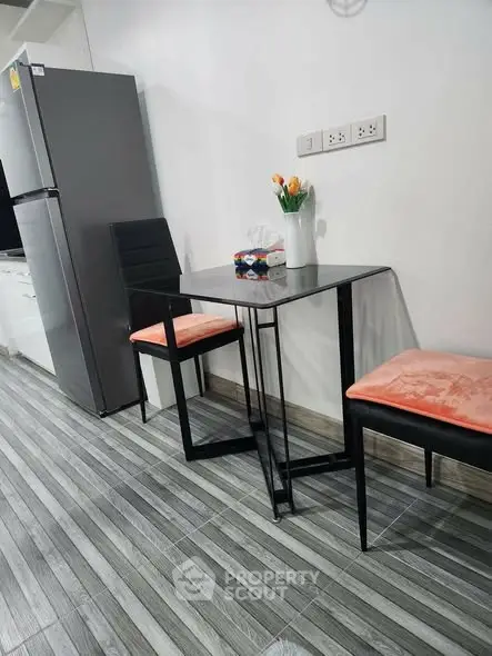 Modern kitchen with sleek dining set and stainless steel fridge