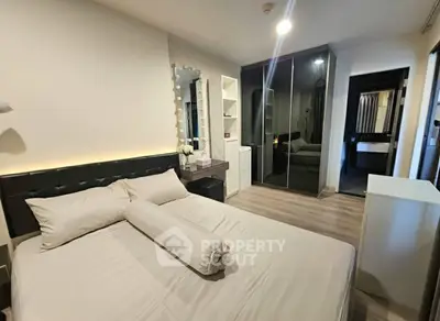 Modern bedroom with stylish decor and ample storage in a contemporary apartment.