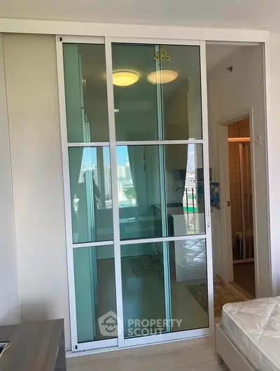 Modern apartment interior with sliding glass doors and city view