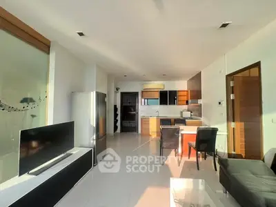 Modern open-plan living room with sleek kitchen and stylish decor