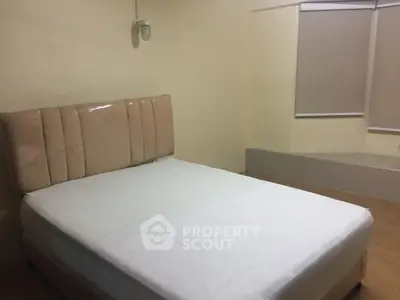 Cozy bedroom with modern bed and neutral tones, perfect for relaxation.