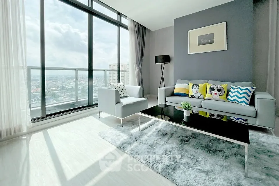 Bright modern living room with floor-to-ceiling windows and stunning city view.