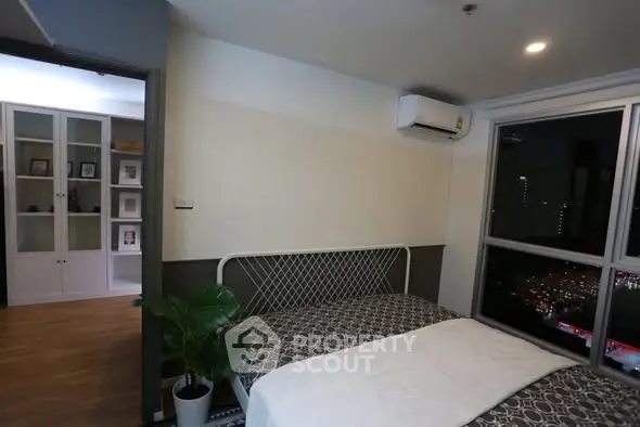 Modern bedroom with city view and air conditioning in stylish apartment