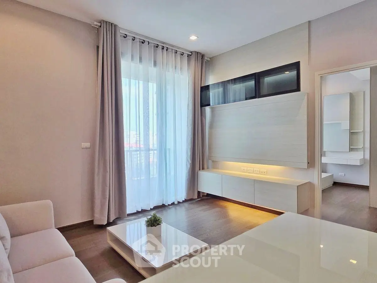 Modern living room with sleek furniture and large window for natural light