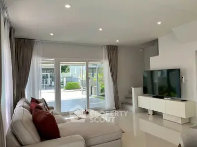 Spacious modern living room with large windows and stylish decor