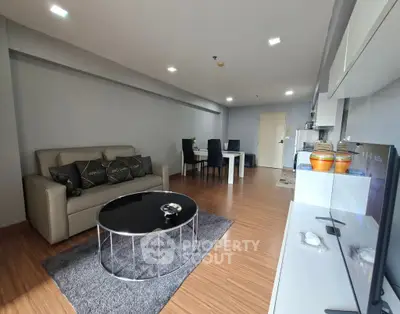 Spacious modern living room with sleek furniture and wooden flooring