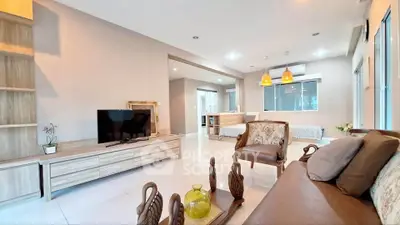 Spacious modern living room with elegant decor and open layout.