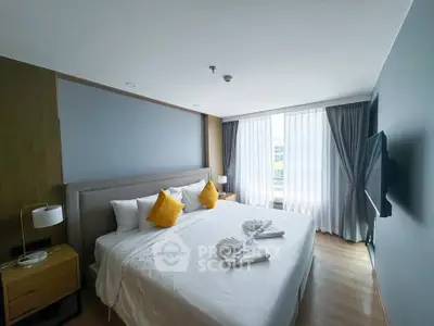 Spacious modern bedroom with large windows and stylish decor