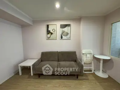 Cozy living room with modern decor and comfortable sofa in a stylish apartment.