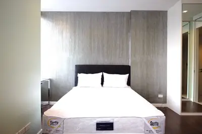 Modern bedroom with stylish decor and comfortable bed in a contemporary apartment.