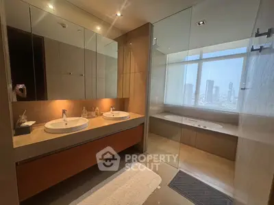 Luxurious modern bathroom with dual sinks and city view from large window