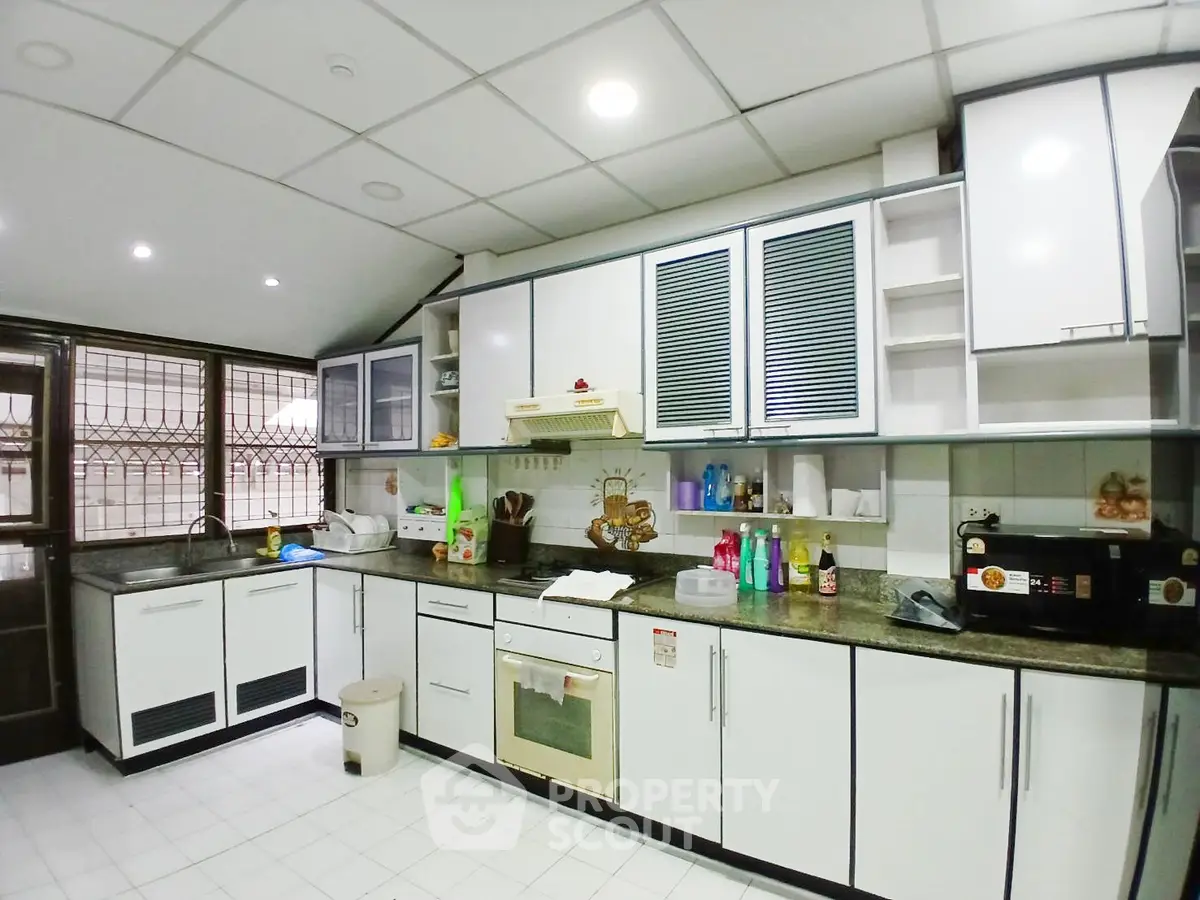 Spacious kitchen with modern appliances and ample storage space