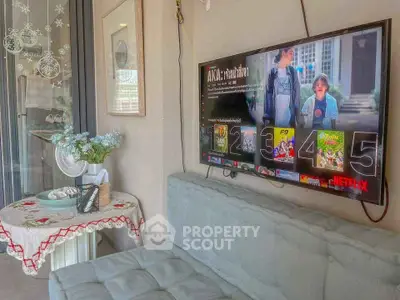 Cozy living area with wall-mounted TV and decorative table setting