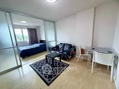 Modern studio apartment with sliding glass doors and stylish furnishings