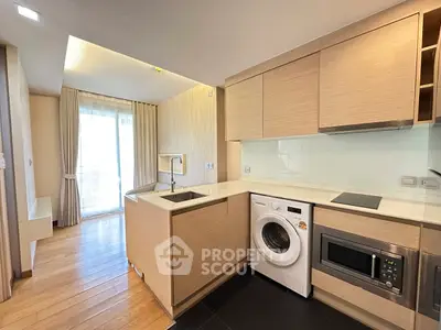 Modern kitchen with integrated appliances and natural light