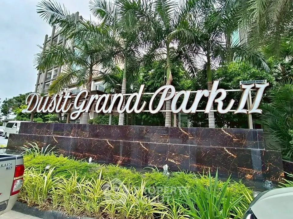 Dusit Grand Park II entrance with lush greenery and modern design