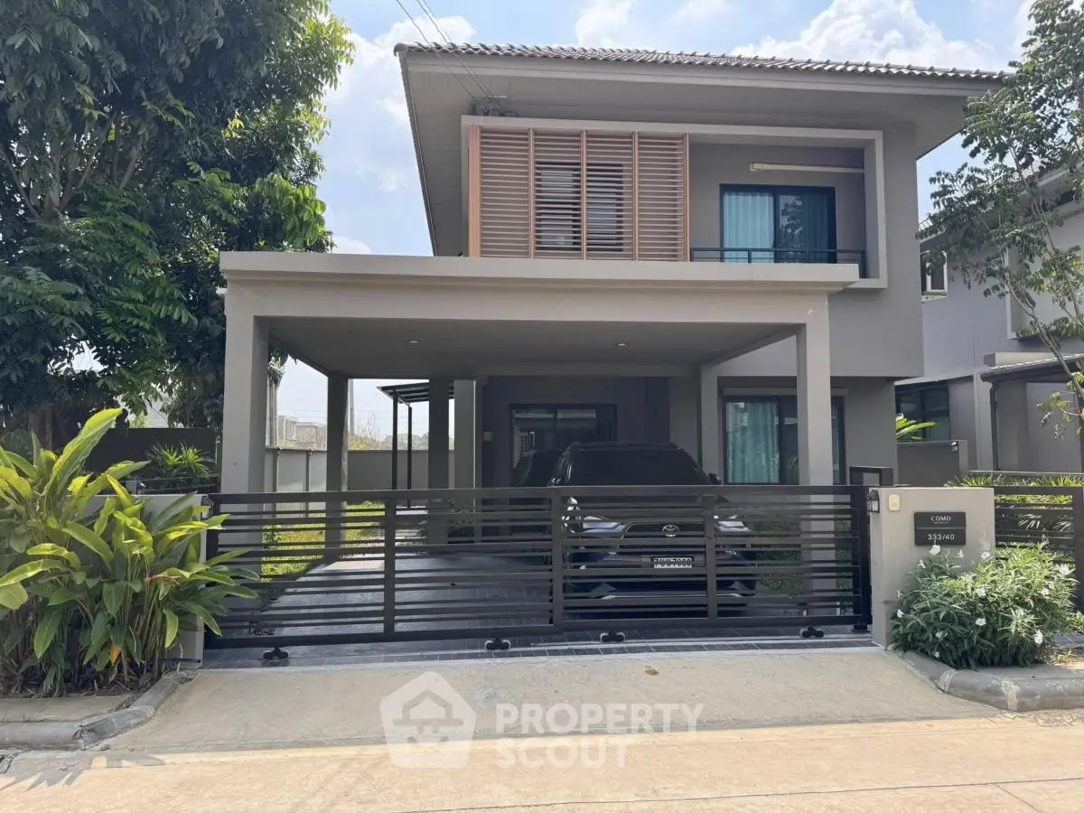 Modern two-story house with carport and lush greenery in a serene neighborhood.