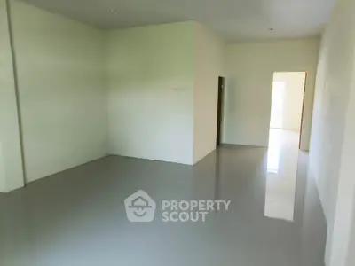 Spacious empty room with glossy floors and neutral walls, ideal for customization.