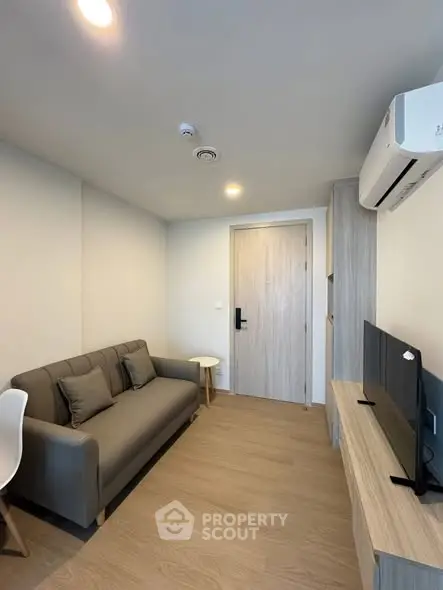 Modern living room with sleek furniture and air conditioning in a cozy apartment.