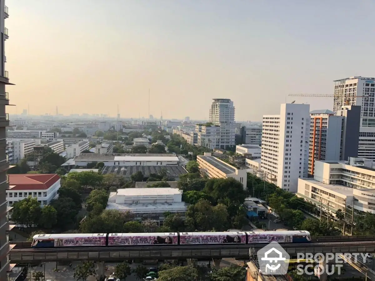 Stunning cityscape view from high-rise apartment with urban skyline and train