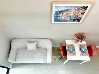Chic modern living room with cozy sofa and elegant dining setup, perfect for urban living.