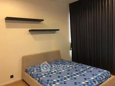 Modern bedroom with stylish bed and minimalist decor, perfect for a cozy living experience.