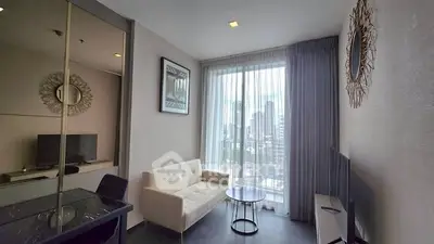 Modern living room with city view, stylish decor, and natural light