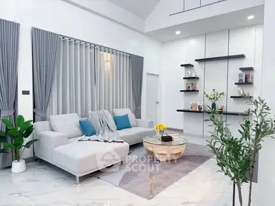 Modern living room with stylish decor, featuring a cozy sofa, elegant curtains, and chic shelving.