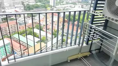 High-rise balcony with stunning city view and air conditioning unit, perfect for urban living.