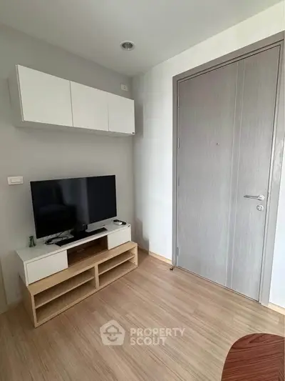 Modern living room with sleek TV stand and wall-mounted cabinets