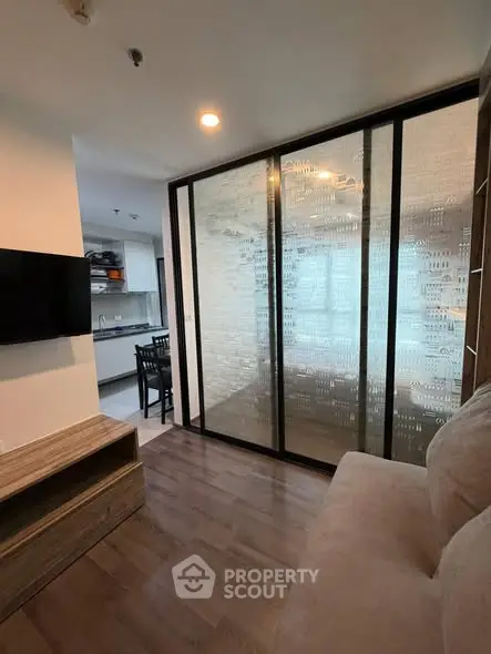 Modern living room with glass partition and open kitchen layout