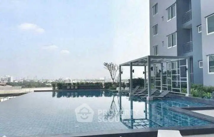 Luxurious apartment building with stunning rooftop pool and city view.