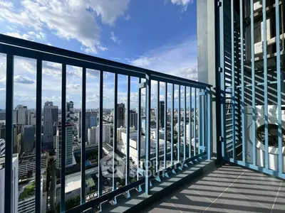 Stunning high-rise balcony with panoramic city skyline views, perfect for urban living enthusiasts.
