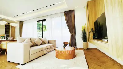 Luxurious living room with modern decor, large windows, and elegant furnishings.