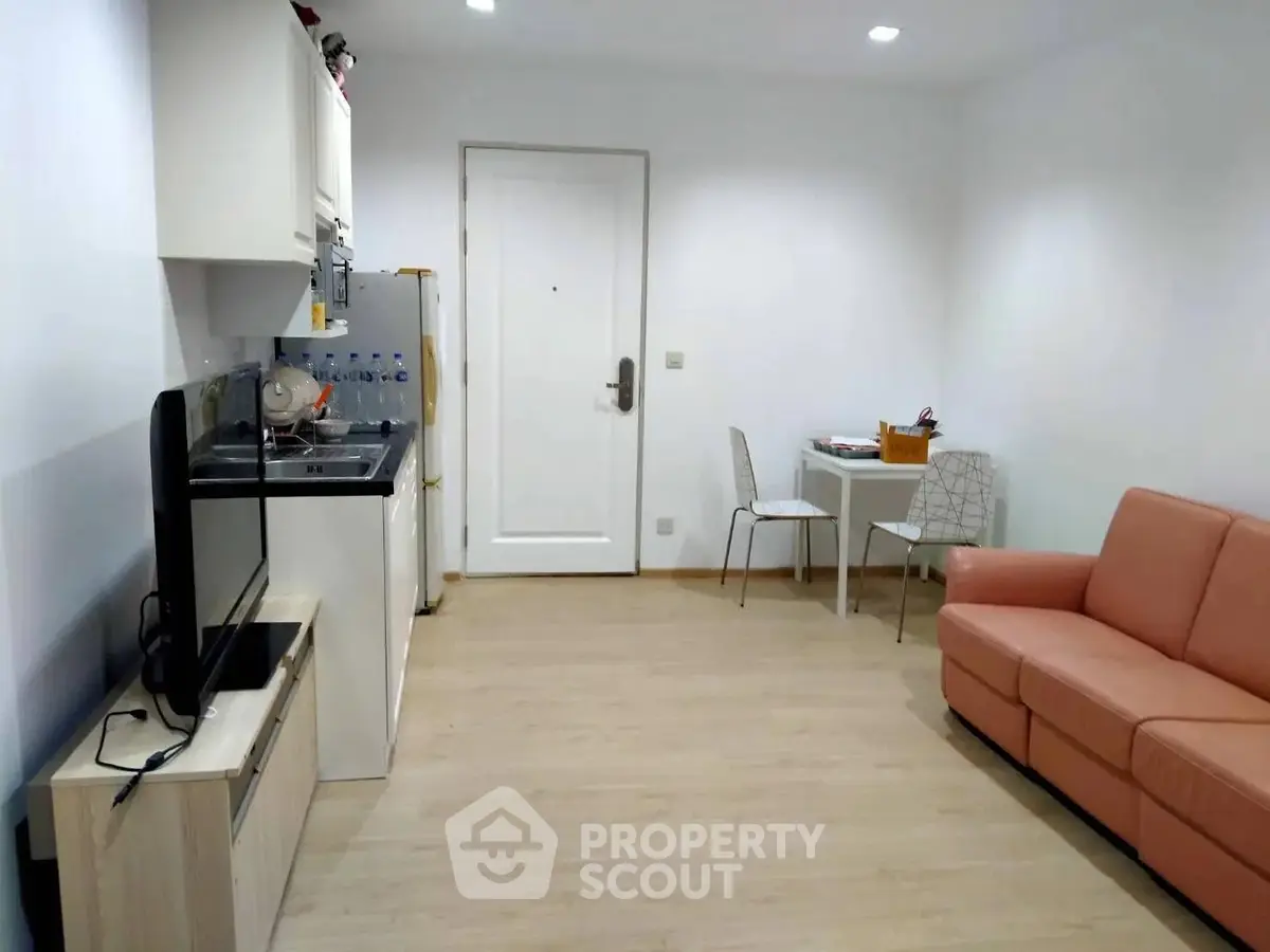 Cozy living room with modern furniture and compact kitchen area