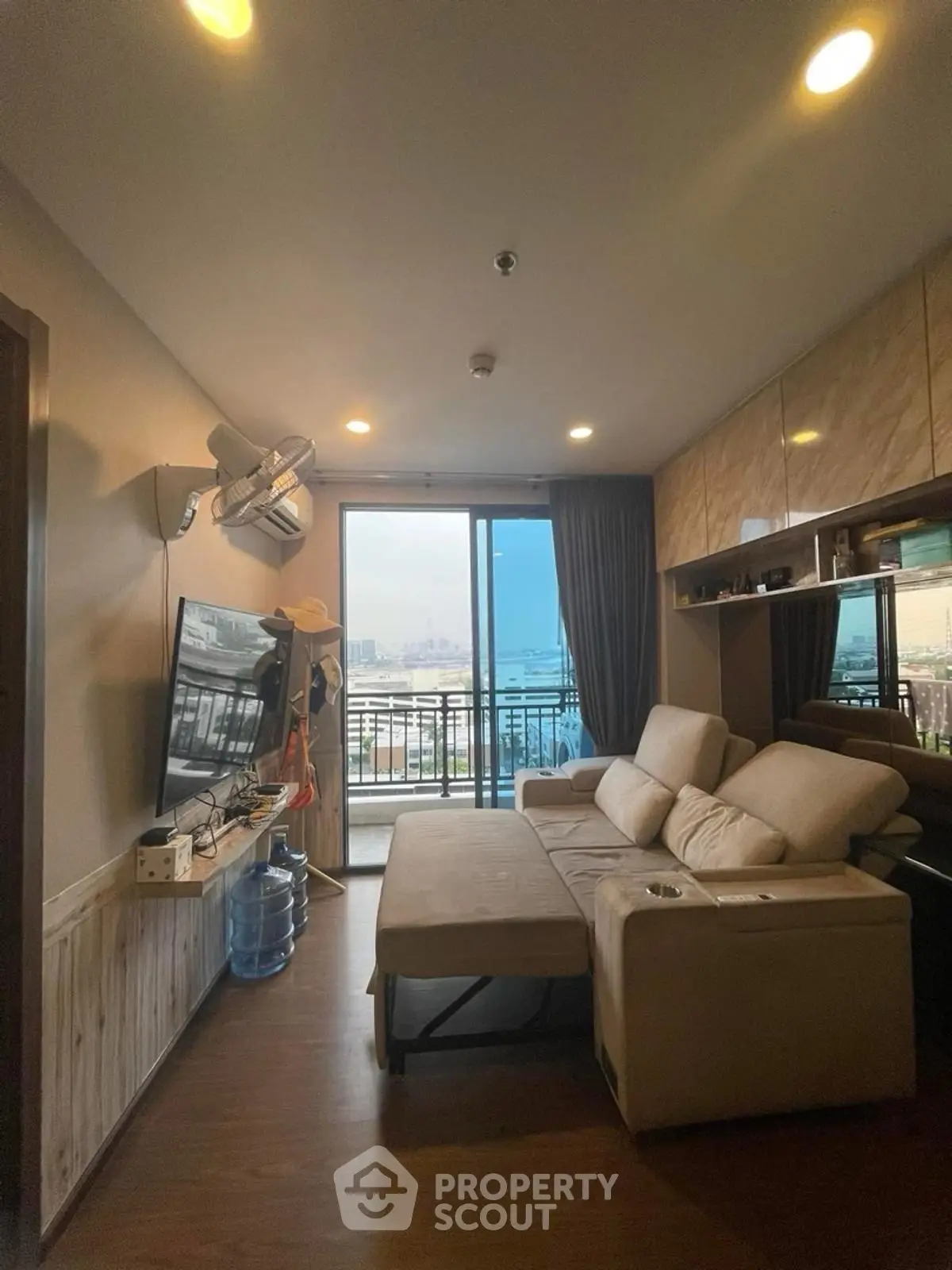Cozy living room with large sofa and balcony view
