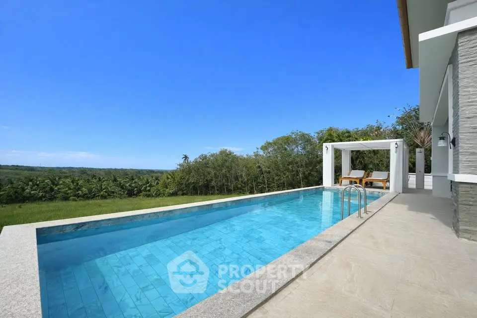Luxurious villa with stunning infinity pool and panoramic views of lush greenery.