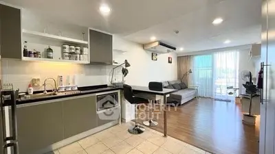 Modern open-plan kitchen and living room with sleek design and natural light.