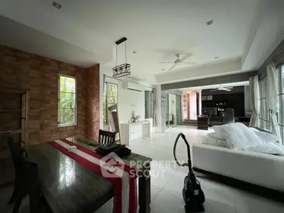 Spacious living room with modern decor and large windows offering natural light.