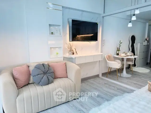 Modern living room with cozy sofa and elegant dining area in open layout apartment.