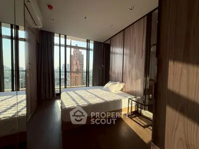 Luxurious bedroom with floor-to-ceiling windows offering stunning city views in a modern high-rise apartment.