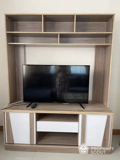 Modern living room with sleek TV stand and flat-screen television