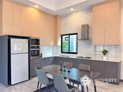 Modern kitchen with sleek cabinetry, stainless steel appliances, and a cozy dining area, perfect for culinary enthusiasts.